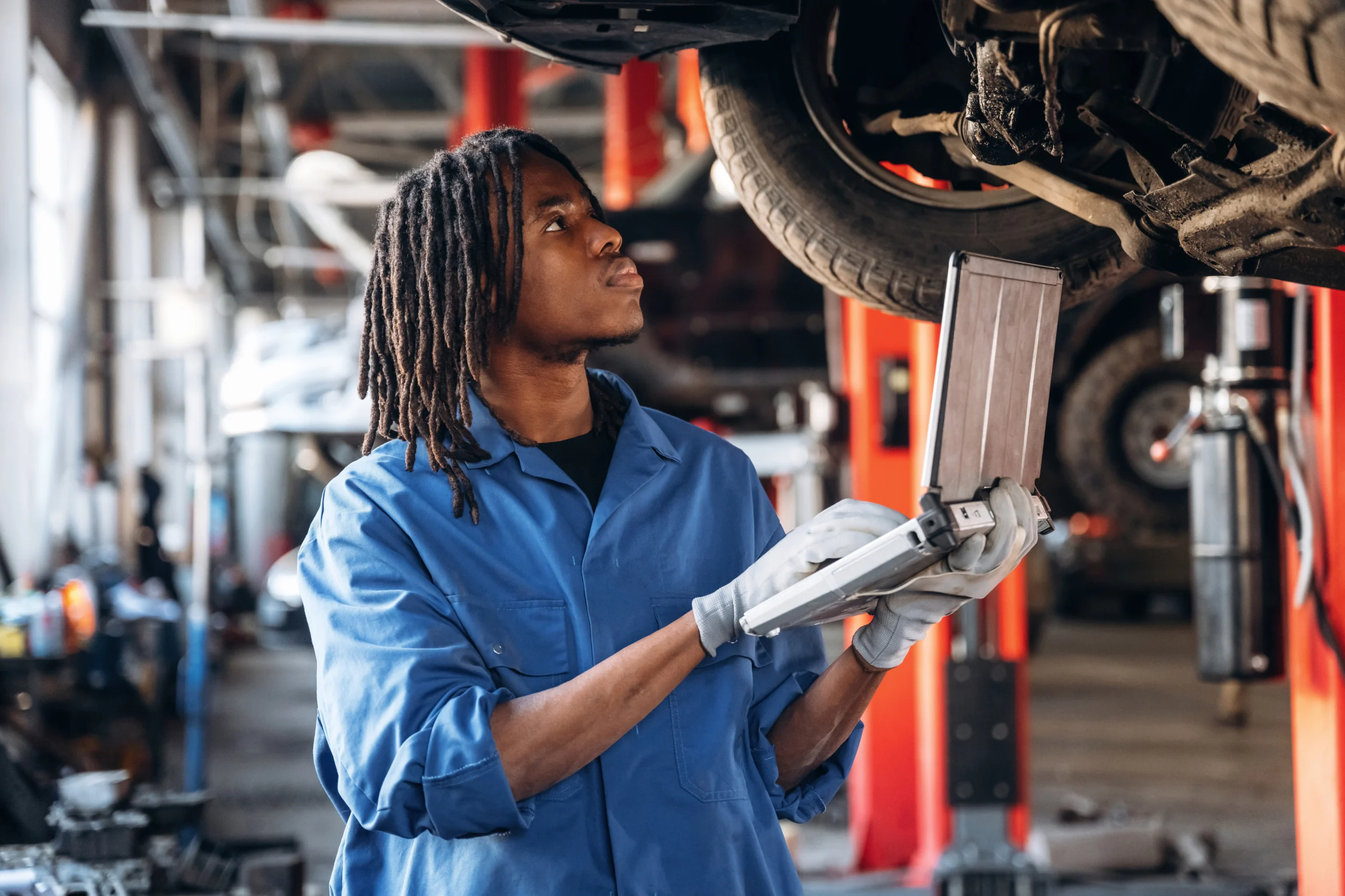 Automotive Lift Technician Inspecting Lift